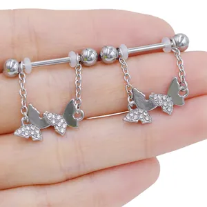 Macro view of crystal butterfly nipple rings with silver chains and barbell piercing studs