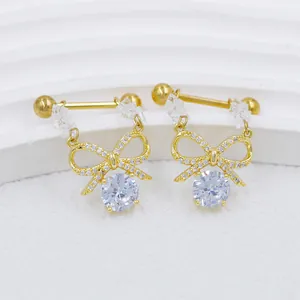 Macro shot of gold butterfly nipple rings with sparkling zircon crystals and chain details