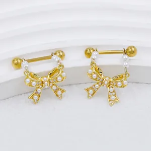 Detail of gold butterfly nipple rings with faux pearls and sparkling zircon accents
