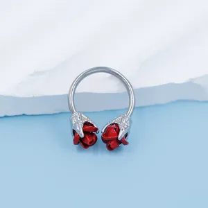 Silver horseshoe septum ring featuring unique claw-set red roses with a matte finish