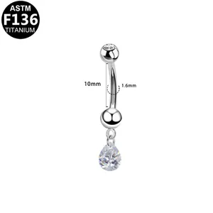 Macro detail of F136 titanium belly ring with 10mm bar and teardrop zircon charm