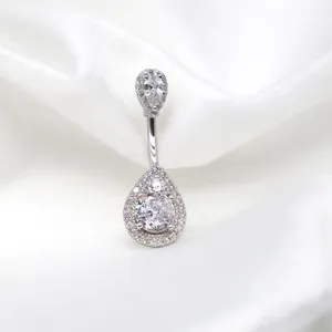 Titanium belly button ring with zircon double teardrop pendant on white velvet fabric