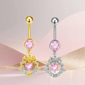 Detail view of heart belly rings with pink zircons in gold and silver finish