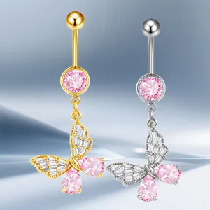 Detailed view of gold and silver butterfly belly rings with pink gems and zircon inlay