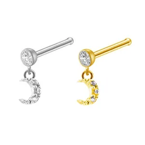 Detailed close-up of 20G titanium moon-shaped nose studs in silver and gold plating