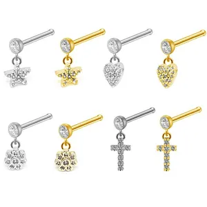 Detail of 20G titanium steel nose studs with star, heart, and cross zircon charms