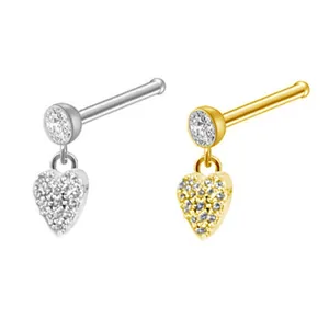 Close-up of heart-shaped nose studs with sparkling crystals in gold and silver finishes