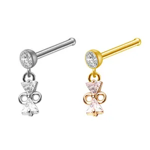 Detail of L-shaped nose studs featuring zircon butterfly pendants in gold and silver finish