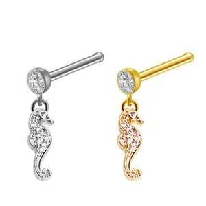 Detailed view of seahorse nose studs in silver and gold with sparkling crystals