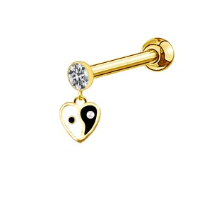 Close-up of golden stud with round zircon and heart-shaped Yin Yang enamel pendant