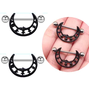 Pair of stainless steel moon nipple rings with hollow star design on a white background