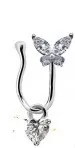 Macro detail of U-shaped nose clip featuring zircon butterfly and heart-shaped pendant