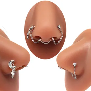 Detailed view of silver stainless steel nose ring chain with moon and star zircon accents