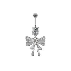 Detailaufnahme vom Bauchnabelpiercing mit Schmetterling, Zirkonia und Herz-Kristall