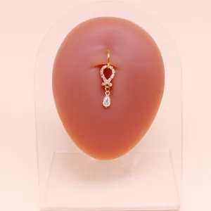 Dettaglio del piercing all'ombelico a farfalla con zircone a goccia su modello