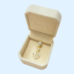 Detail von goldenem Schmetterlings- und Herzschmuck mit weißem Zirkonia in einer Box
