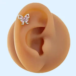 Detailed view of pink zircon butterfly wing ear stud on skin-tone silicone ear model