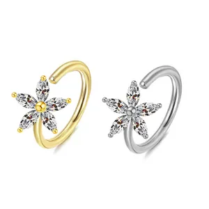 Detailed view of silver and gold flower nose rings with marquise-cut zircon stones