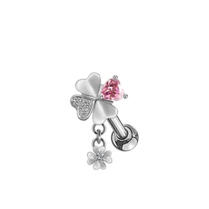 Macro view of four-leaf clover stud with pink heart zircon and micro-pave crystals