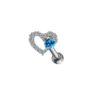 Close-up of heart-shaped tragus piercing with blue zircon and white crystal pave