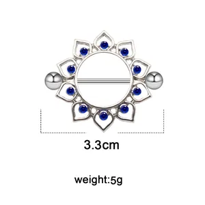 Detail of silver nipple ring featuring a blue rhinestone floral frame and bar