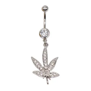 Macro view of silver belly ring with zircon and sparkling maple leaf pendant
