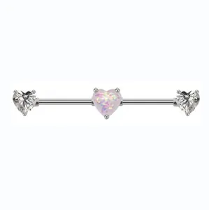 Macro detail of industrial barbell earring with pink opal heart and clear cubic zirconia