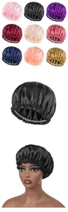 Close-up of nine colorful satin sleep bonnets with elastic edges and smooth finish