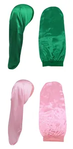 Detail of satin long hair bonnets in green and pink with elastic band for hair protection