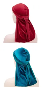 Detailed back view of velvet durags in burgundy and peacock blue colors with long tails