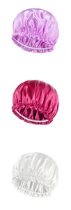 Close-up of purple, pink and white satin bonnets with elastic ruffle band details