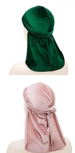 Detail of velvet durag long straps showing premium fabric texture in pink and dark green