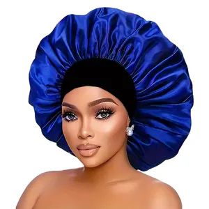 Detail showing the glossy royal blue satin texture and black elastic band of the sleep bonnet