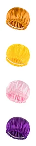 Macro shot of satin sleep bonnets in gold, yellow, pink, and purple with elastic bands