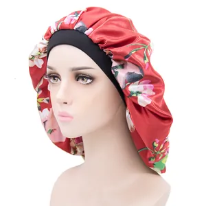 Floral red satin sleep bonnet with a black elastic headband on a model head