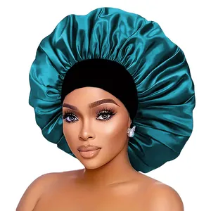 Close-up of peacock blue satin sleep bonnet with a wide black elastic headband