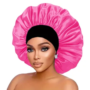 Close-up of bright pink satin sleep bonnet featuring a wide black elastic headband
