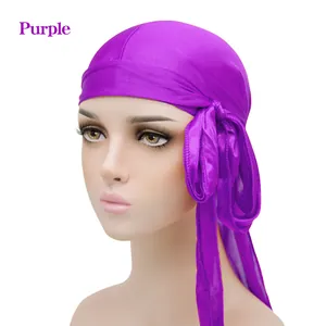 Silky purple durag with long tail and tie-strap design on a mannequin head