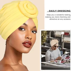 Stylish bright yellow pleated turban hat for women featuring a bohemian snail knot design