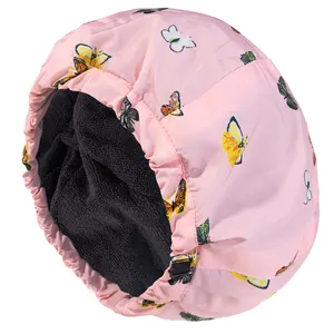 Detail of the pink butterfly print outer layer and black absorbent towel lining of the shower cap