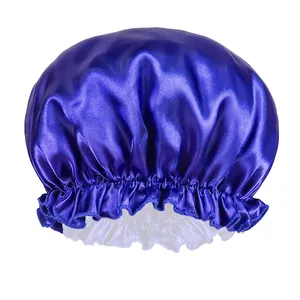 Detail of dark blue satin sleep cap showing the elastic band and ruffled edges