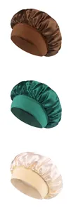 Detailed view of three satin hair bonnets in brown, dark green, and champagne gold