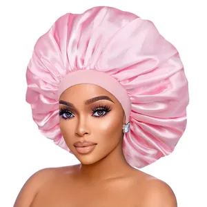 Detailed view of large pink satin bonnet showing smooth texture and elastic headband