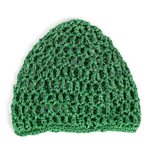 Close-up of grass green crochet mesh knit hat with detailed handmade openwork texture