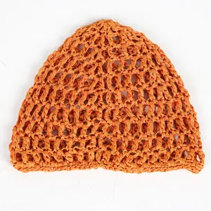 Macro detail of ginger orange crochet mesh hat with hollow knit texture and fiber patterns