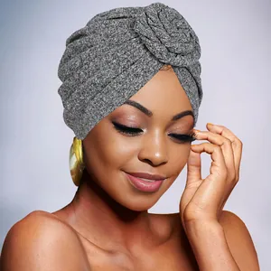 Close-up of bohemian turban hat with grey knit texture and circular fold detail