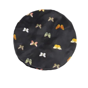 Elastic satin bonnet with colorful butterfly print on black fabric for hair protection