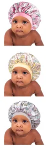 Close-up of baby satin bonnets with unicorn prints in pink, beige and blue colors