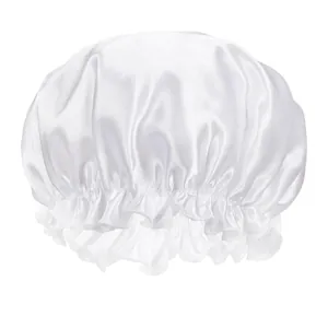 Close-up of white satin sleep cap featuring ruffled elastic edge and glossy texture