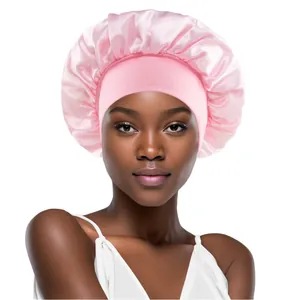Pink satin elastic sleep cap for hair care, wide band bonnet shown on a model
